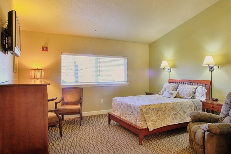 Guest room with a bed and TV at The Family House