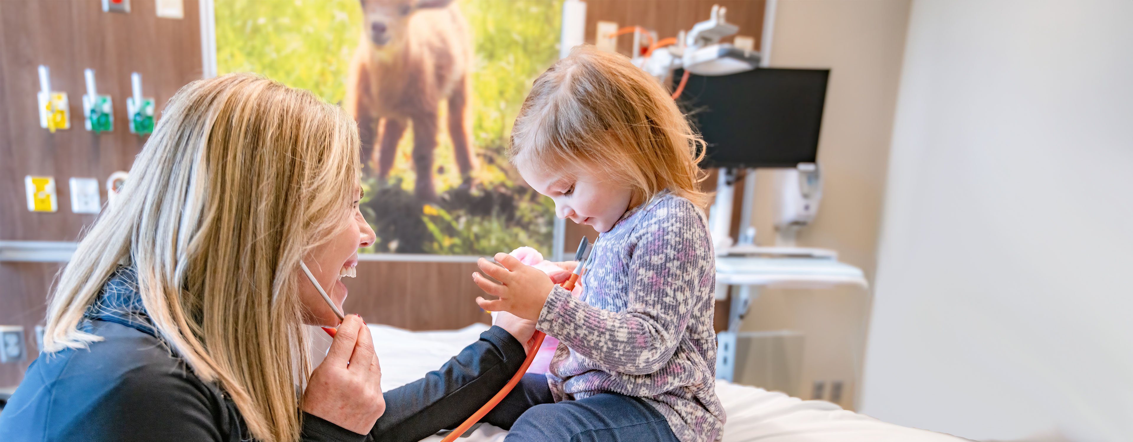 Nurse with pediatric patient in room.