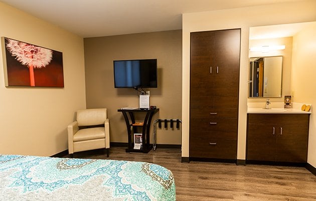 Vanity, Dressers, TV and chair in guest room