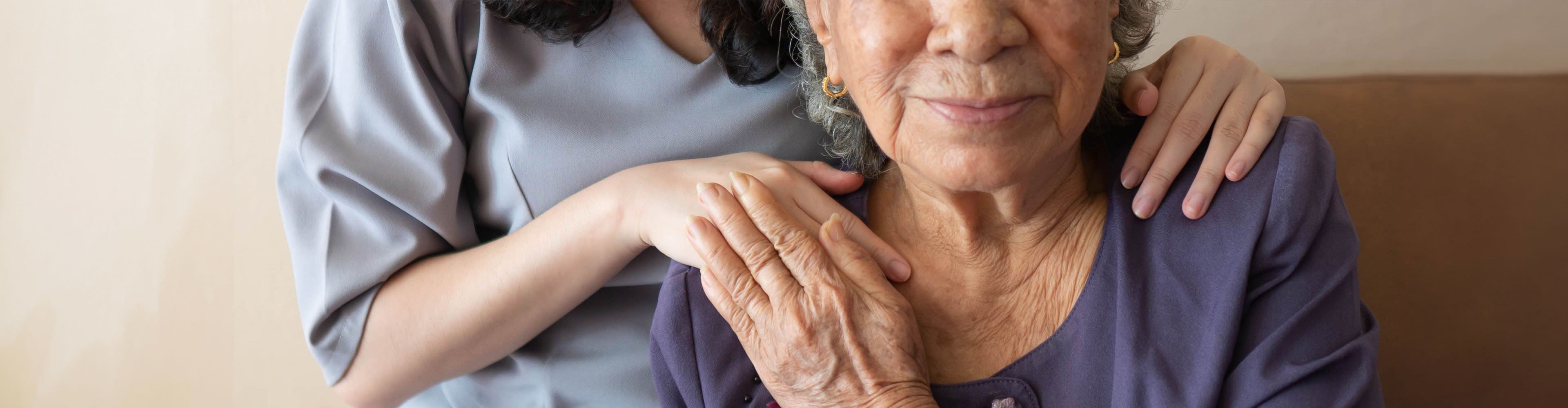 Photos of a woman holding hands with of a caregiver